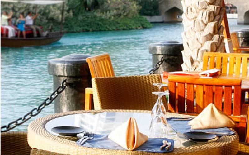 Apricot Dubai riverside table with scenic waterfront view